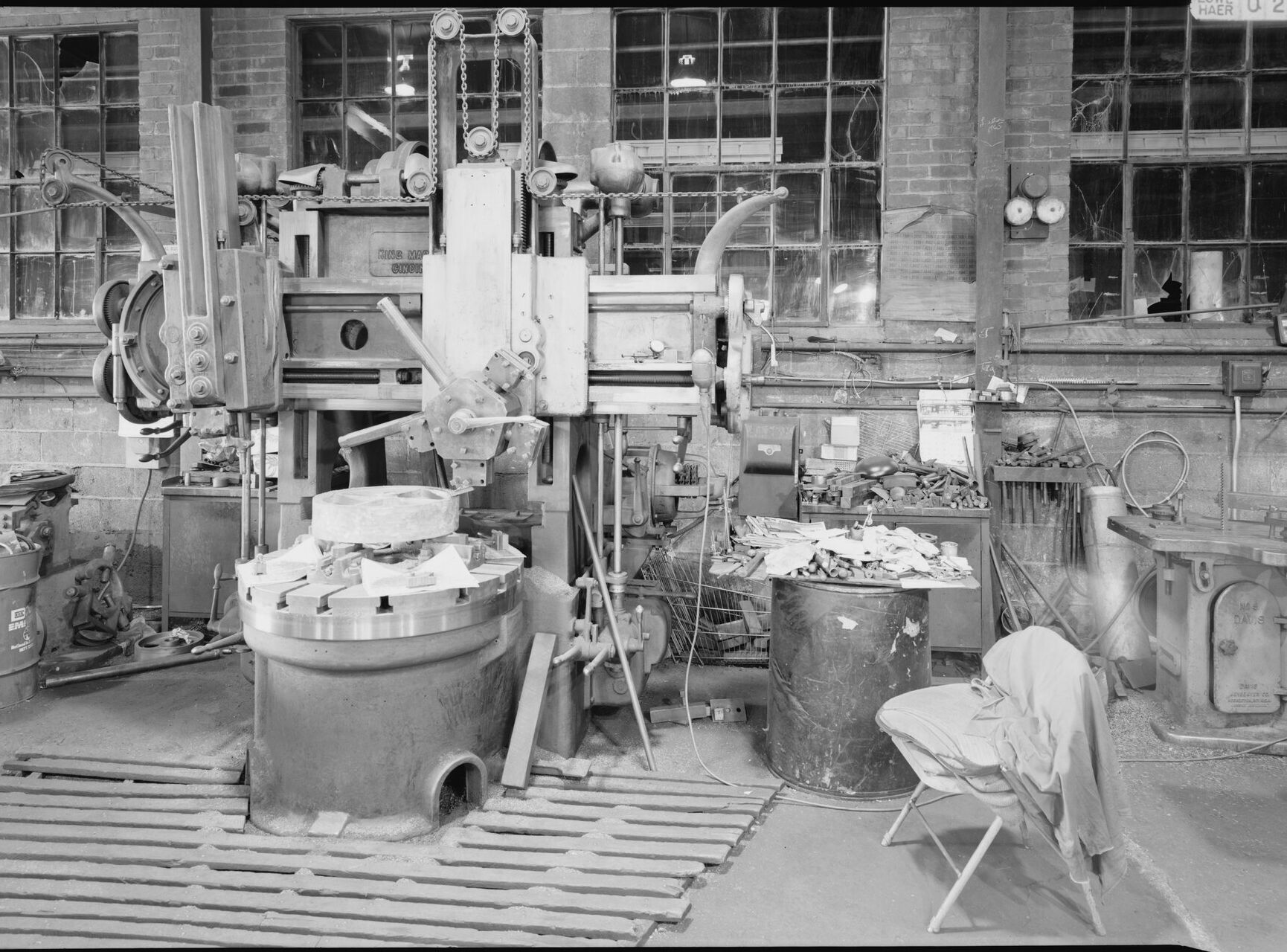 A machine shop floor with a vertical boring machine.